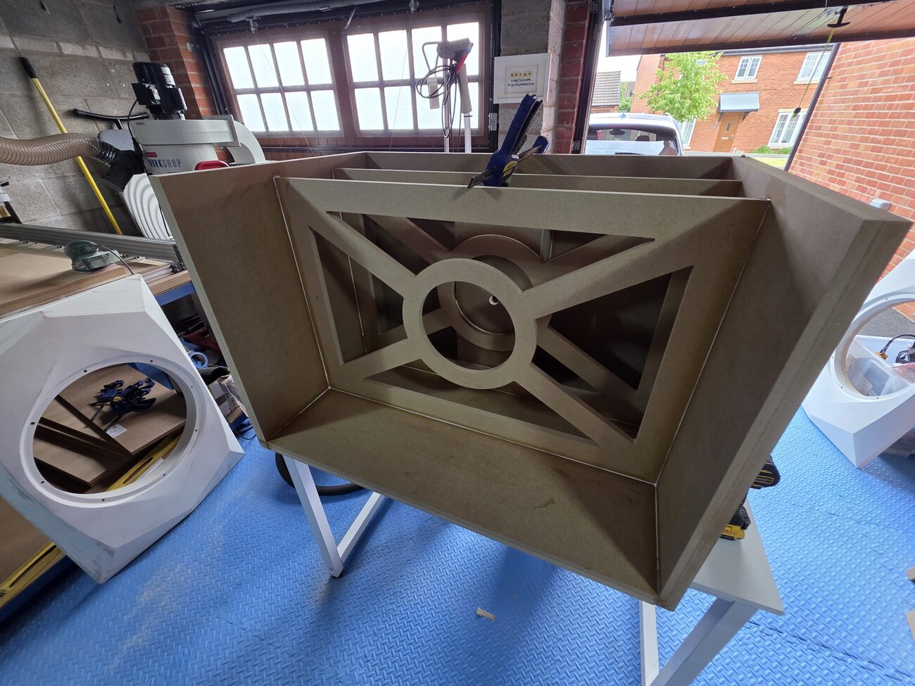 A raw faceted XOP cabinet on the bench