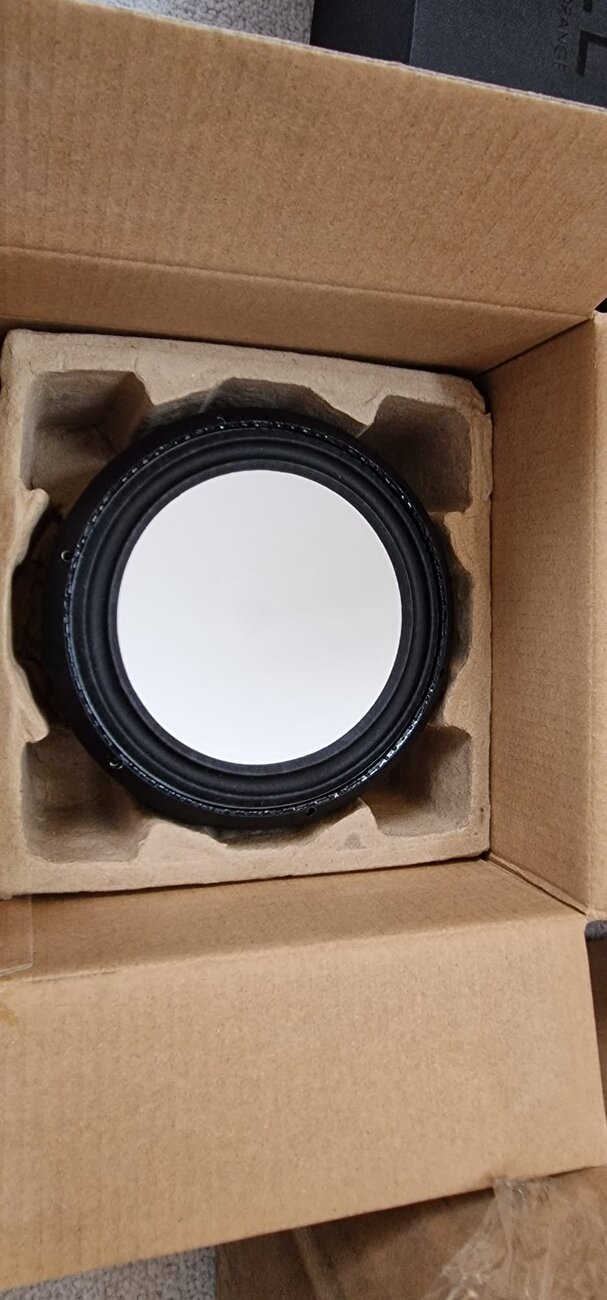 A loudspeaker driver being unboxed and tested