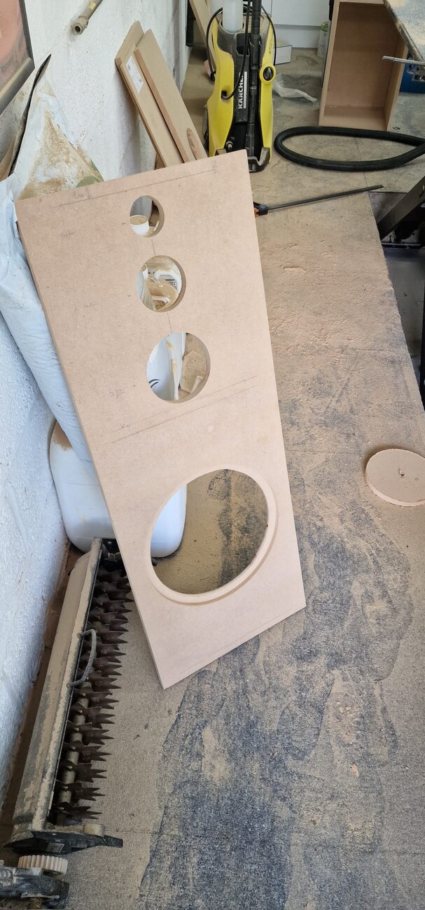 A hand-cut speaker baffle with driver holes