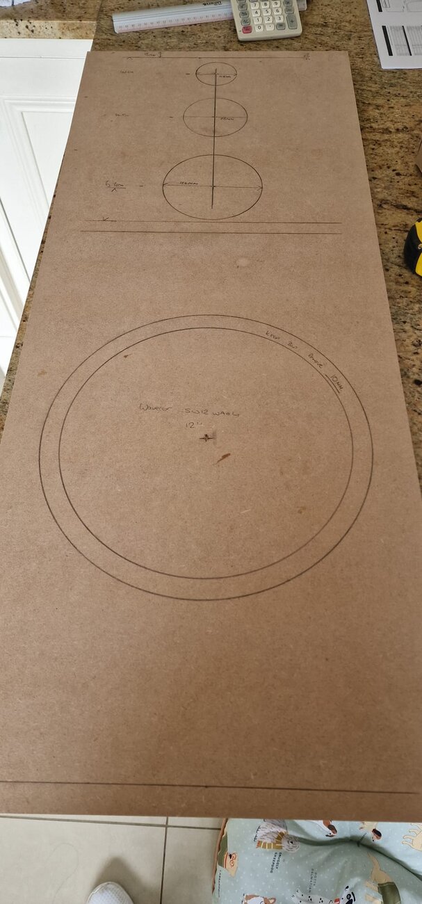 A cabinet baffle marked out by hand with compass and pencil on MDF