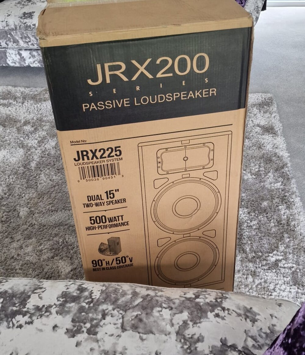 A pair of 500-watt dual-15 PA loudspeakers, still boxed